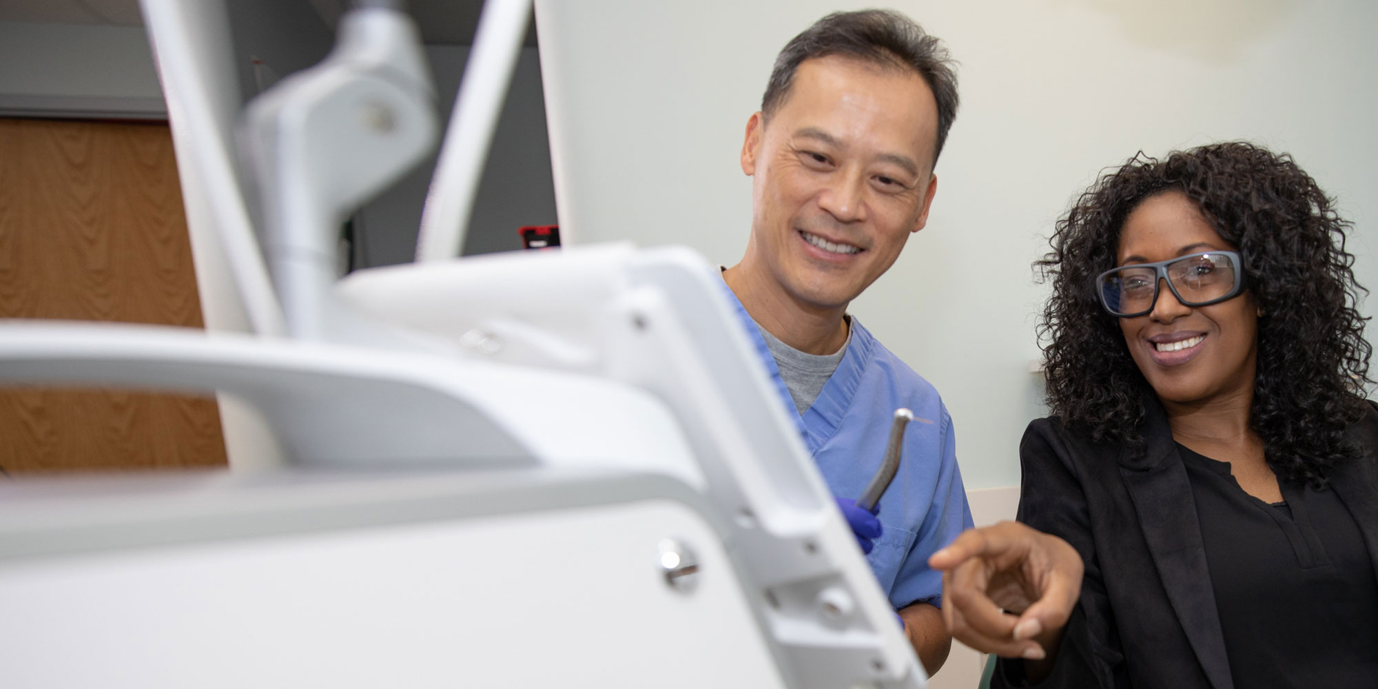 dr wang discussing dental laser treatment Annandale, VA