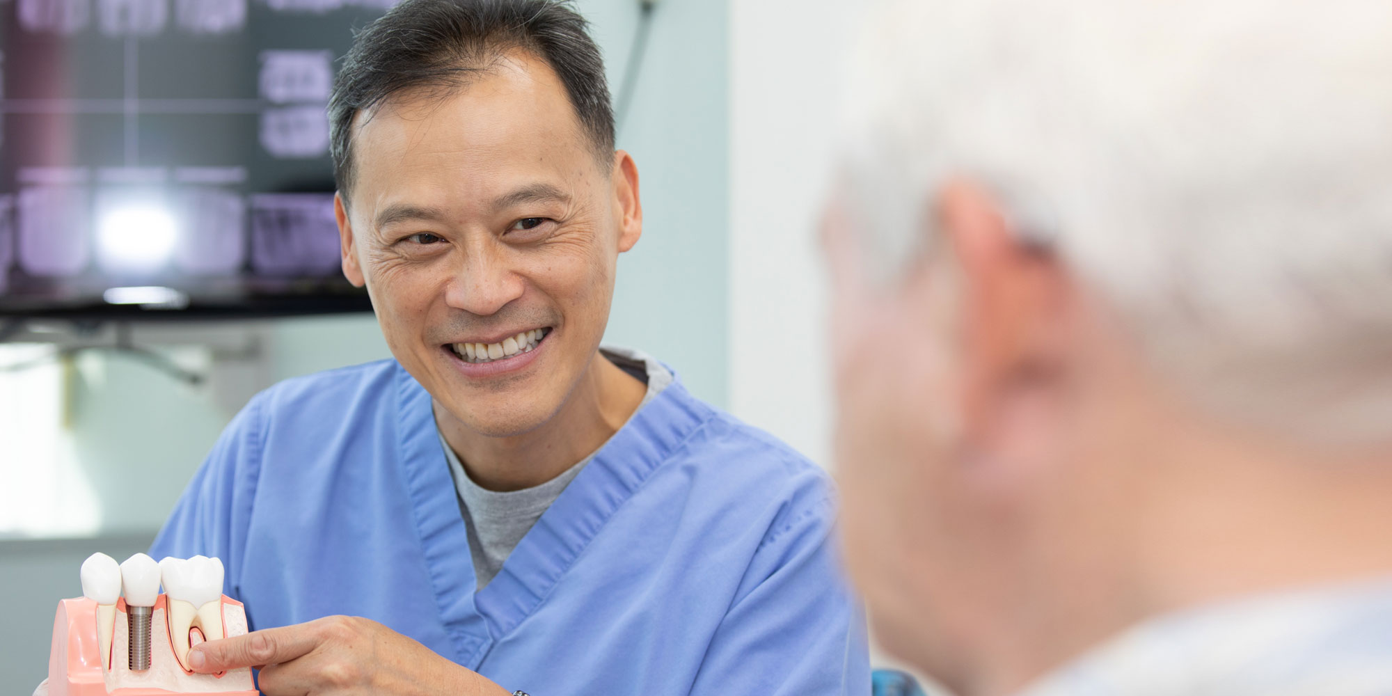 dr wang discussing peri implantitis with patient Annandale, VA
